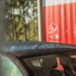 A,Car,With,Water,Droplets,On,Its,Roof,And,Windshield,