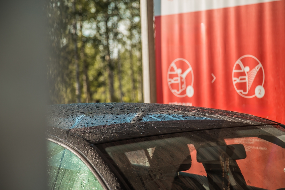 A,Car,With,Water,Droplets,On,Its,Roof,And,Windshield,