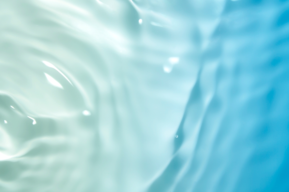 A,Soothing,Turquoise,Water,Surface,Featuring,Gentle,Ripples,And,Reflections.